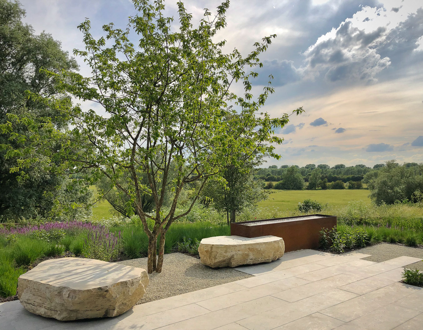 Colm Joseph Gardens Cambridgeshire Garden design multi stem tree corten steel water feature boulder seats landscape views