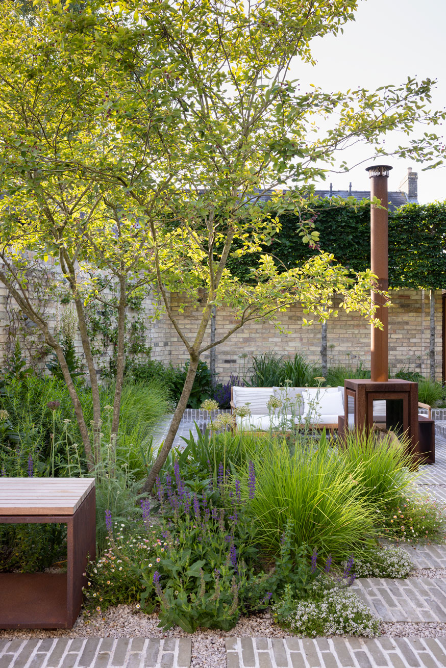 Colm Joseph Cambridge courtyard garden clay pavers multi-stem amelanchier tree corten furniture