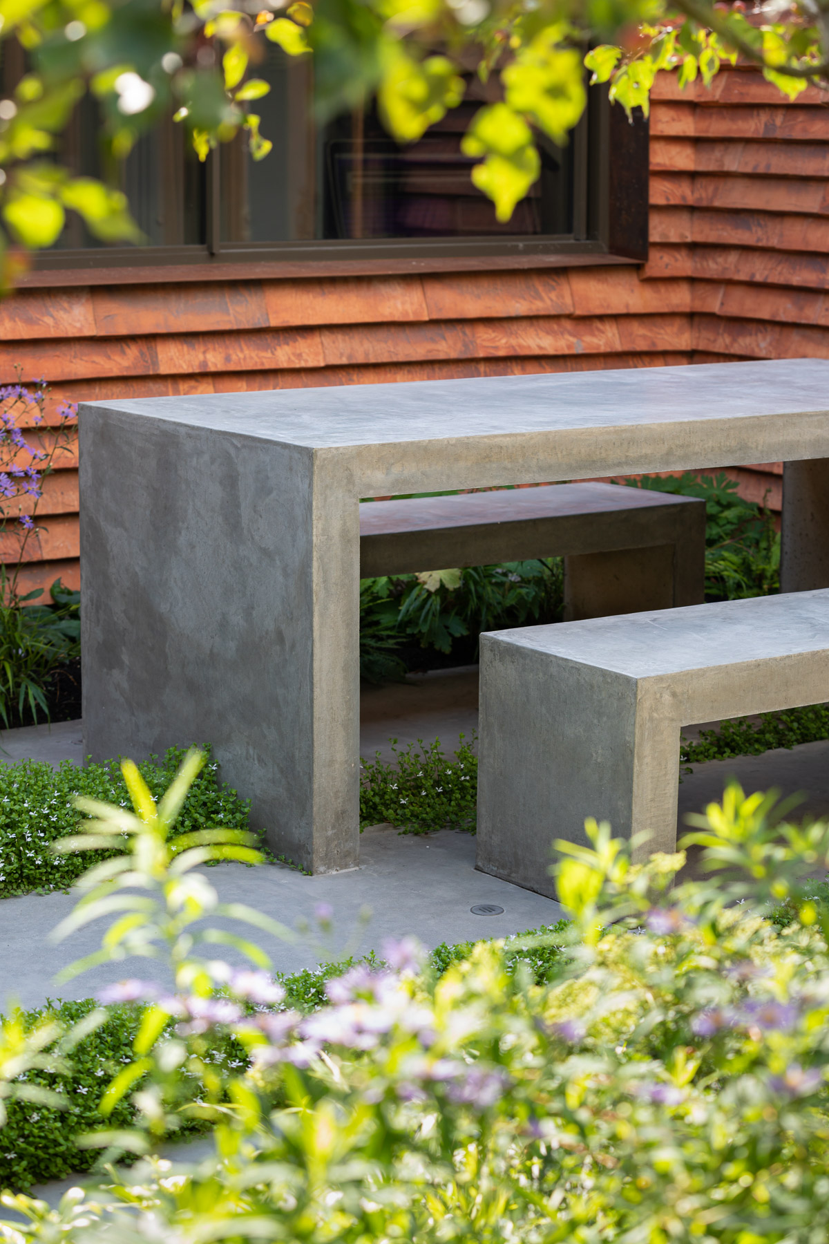 Colm Joseph Cambridge garden designer concrete table and benches concrete paving perennial 
