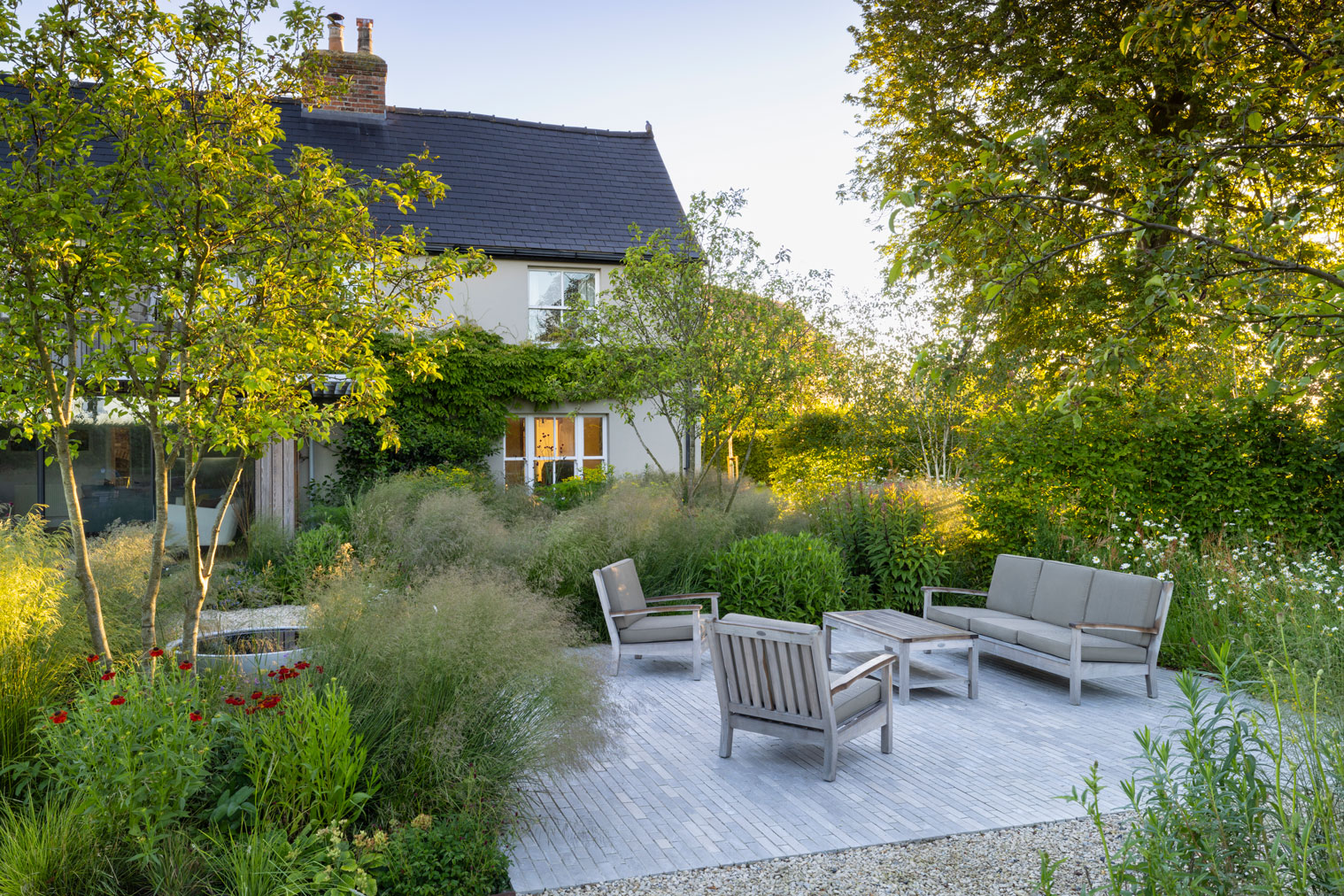 Colm Joseph Cambridgeshire country garden modern lounge seating area limestone pavers multi-stem malus tree water bowl naturalistic planting design