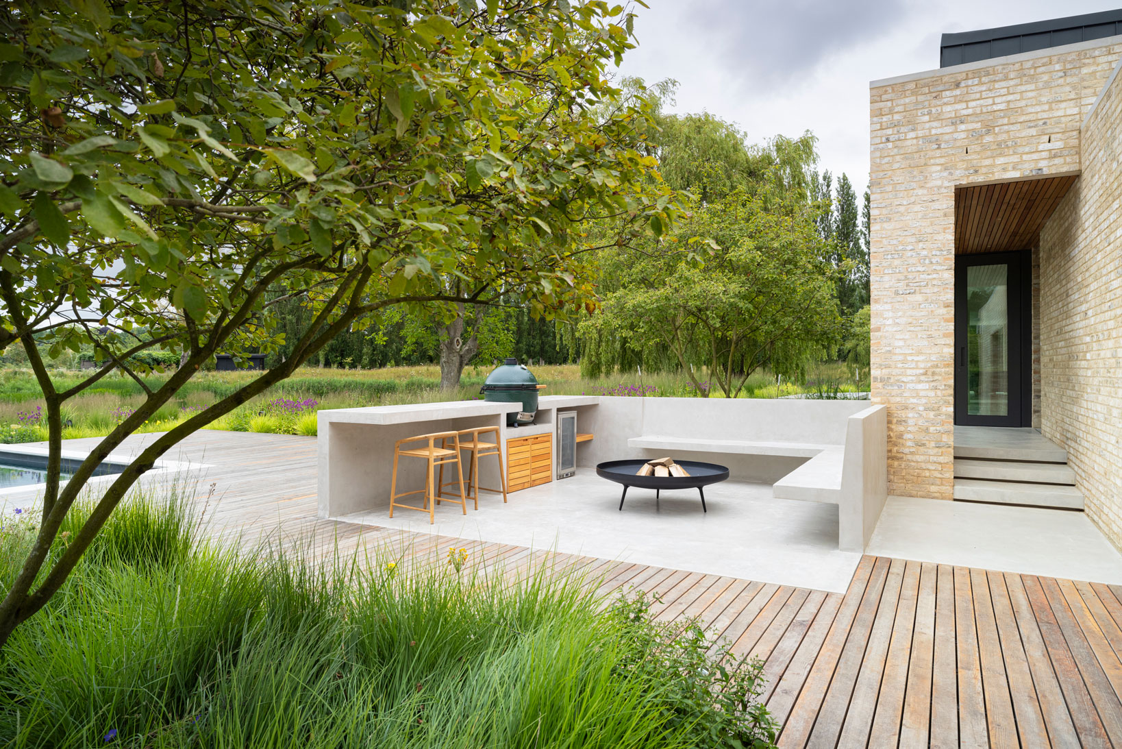 Colm Joseph modern country garden cambridgeshire bespoke outdoor kitchen concrete cantilevered bench floating steps timber deck natural planting