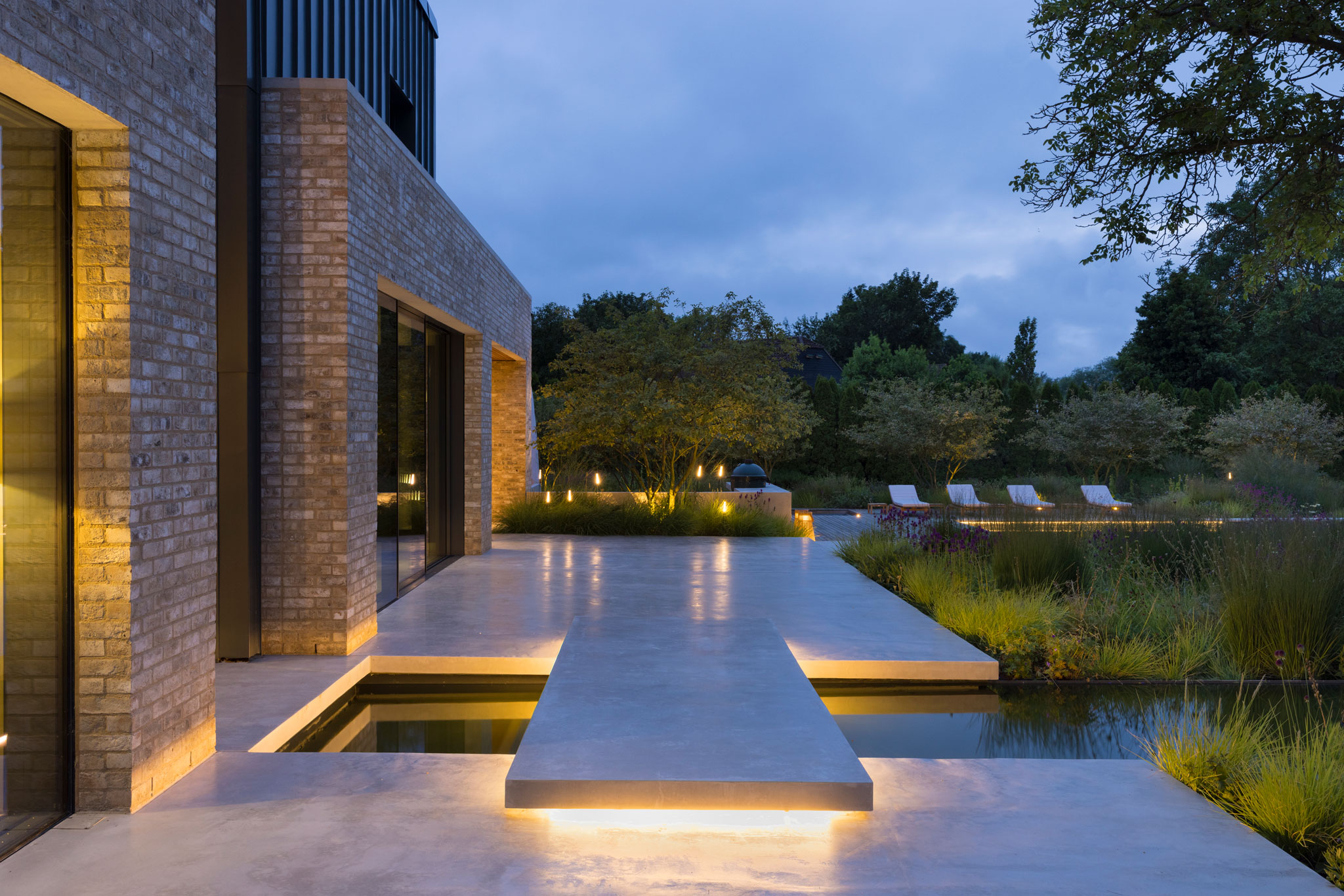 Colm Joseph modern country garden cambridgeshire concrete terrace floating path over water feature outdoor lighting naturalistic planting design