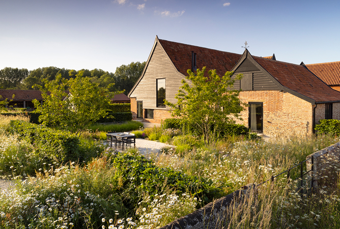 Colm Joseph suffolk garden converted barn modern home naturalistic planting design wildflower meadow beech hedge multi-stem crabapple trees seating area